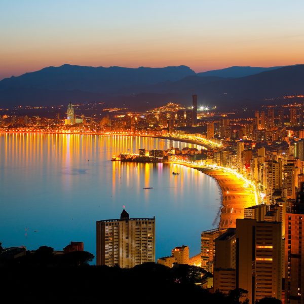 Panorama of the beach in Benidorm and night lights of the city at sunset (Spanish coast)